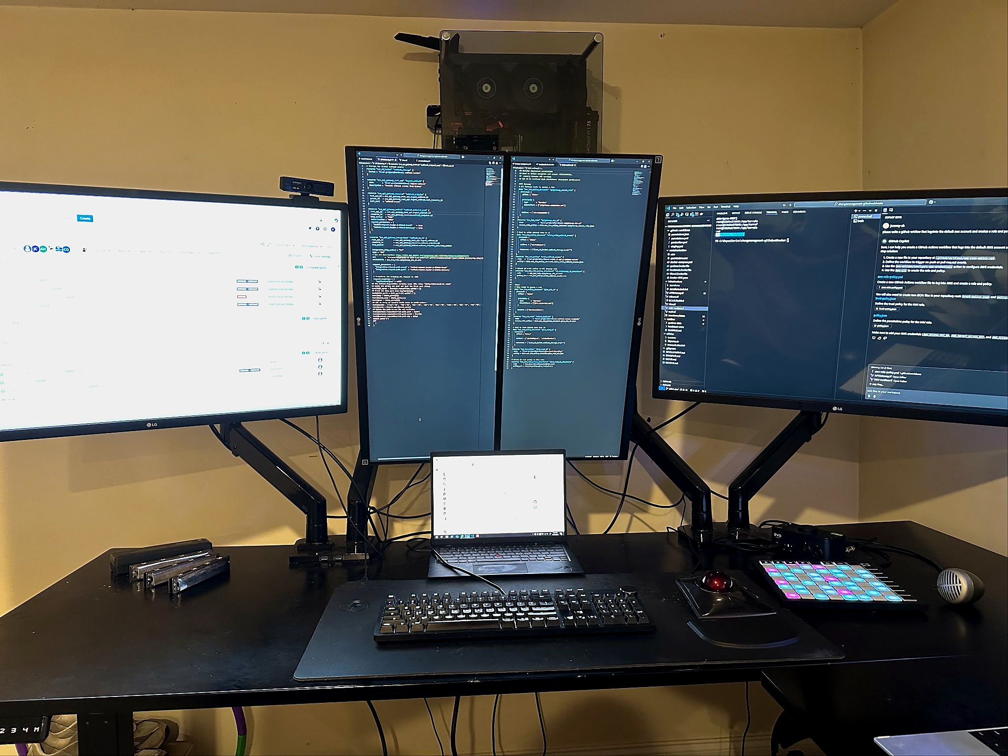 James Croney's multi-monitor workstation with code, development tools, and hardware controls.