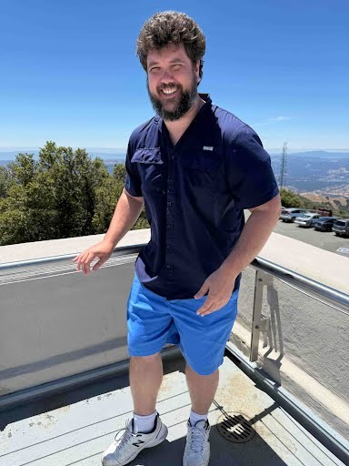 James Croney standing outdoors on a sunny overlook.